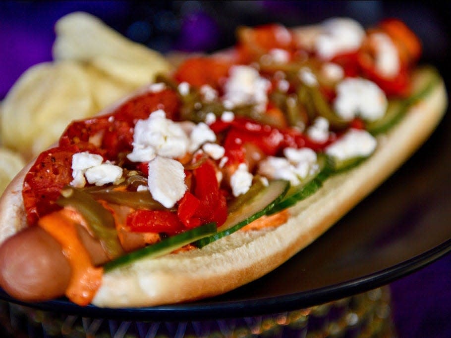 hot dog with feta cheese sundried tomato toppings