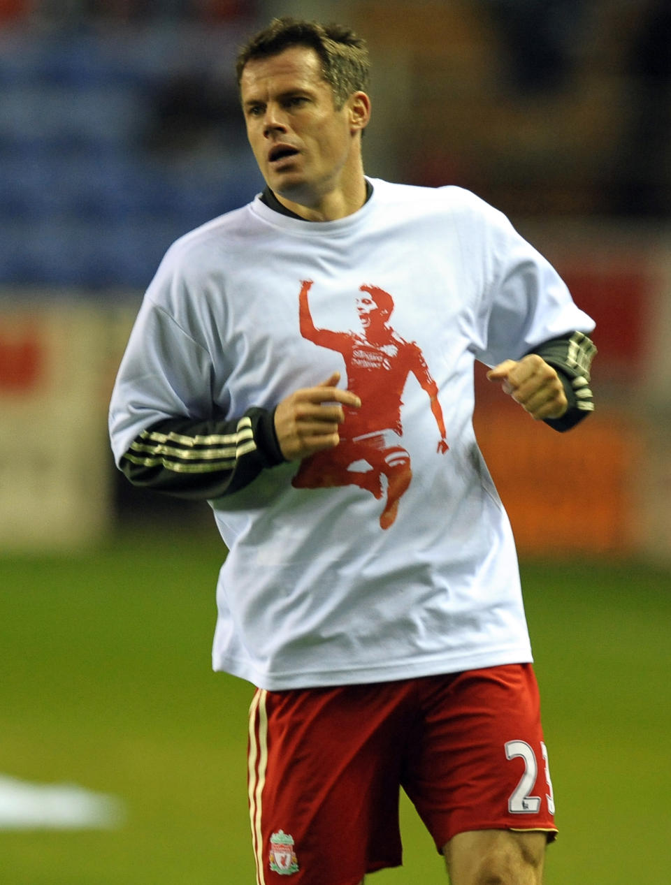 Liverpool's English defender Jamie Carragher warms up wearing a t-shirt supporting team-mate Luis Suarez (PAUL ELLIS/AFP/Getty Images)