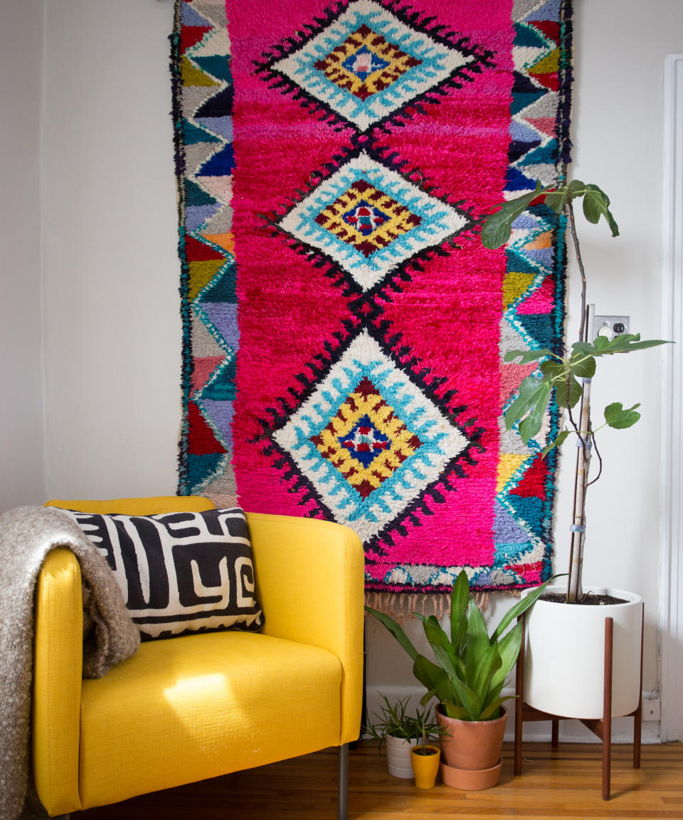 <p> Hang a wonderfully bright, patterned rug as wall art, in a jungalow-inspired, boho living room design.  </p> <p> Kristina Williamson, Founder + CEO of OUIVE, says: 'Living rooms are where you get to set the tone for your free time. It’s a place to lounge, play, and get together with loved ones. Designing a colorful living room can energize your home and showcase your personal style.' </p> <p> 'Textiles are a great way to add color to your living room: an eye-catching rug, wall hanging, pillows, or throw blankets are easy ways to incorporate color into your home.' </p>