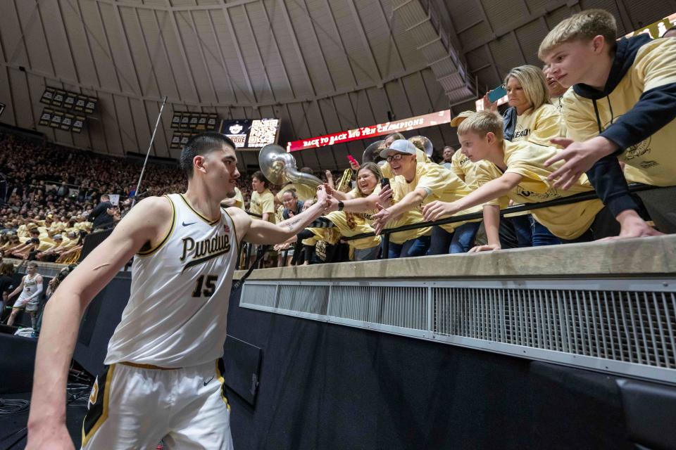 Purdue center Zach Edey high fives the student section after a game against Michigan State at Mackey Arena.