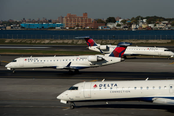 Delta Air Lines Inc. planes sit on the runway at LaGuardia Airport (LGA) in New York, U.S., on Monday, Oct. 21, 2013. Delta Air Lines Inc. is scheduled to release earnings figures on Oct. 22. Photographer: Ron Antonelli/Bloomberg via Getty Images