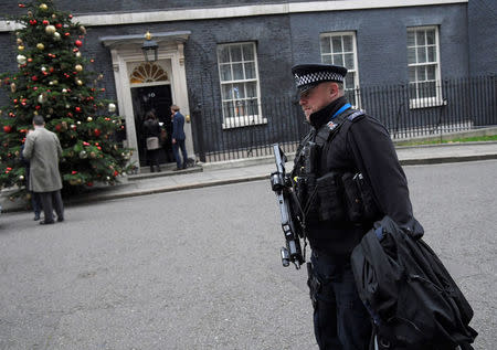 An armed police officer walks past 10 Downing Street, London, Britain, December 6, 2017. REUTERS/Toby Melville