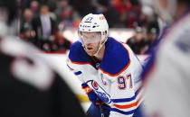 Edmonton Oilers center Connor McDavid faces off against the Ottawa Senators during first period of an NHL hockey game in Ottawa on Saturday, Feb. 11, 2023. (Sean Kilpatrick/The Canadian Press via AP)