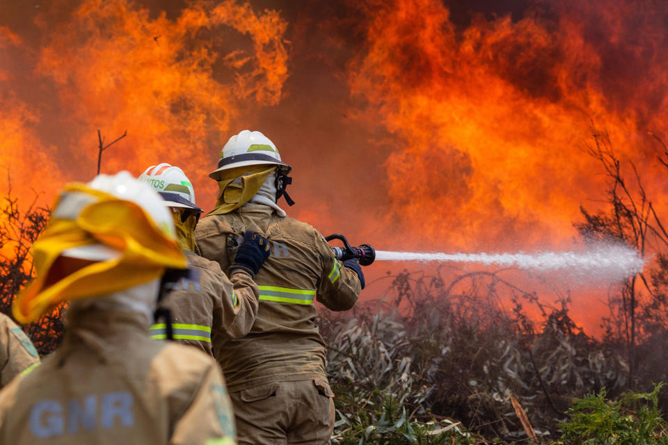 <p>Portuguese National Republican Guard firefighters battle a forest fire in Capela Sao Neitel, Alvaiazere, central Portugal, June 18, 2017. At least 62 people have been killed in forest fires in central Portugal, many of them trapped in their cars as flames swept over a road Saturday evening. (Paulo Cunha/EPA/Rex/Shutterstock) </p>