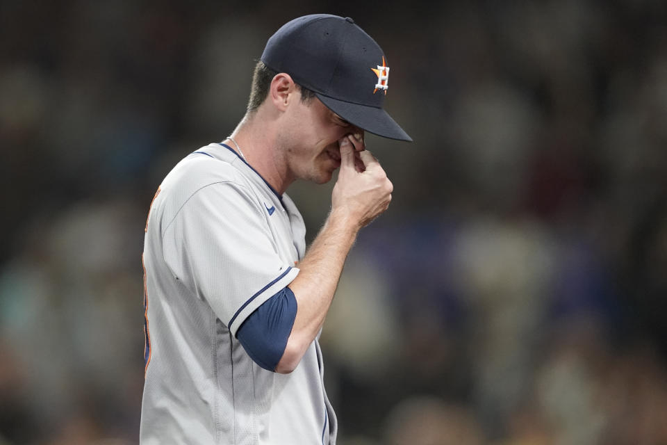 Houston Astros relief pitcher Brooks Raley holds his nose after he was ejected from a baseball game against the Seattle Mariners after he hit Seattle Mariners' J.P. Crawford with a pitch during the eighth inning, Monday, July 26, 2021, in Seattle. The Mariners won 11-8. (AP Photo/Ted S. Warren)