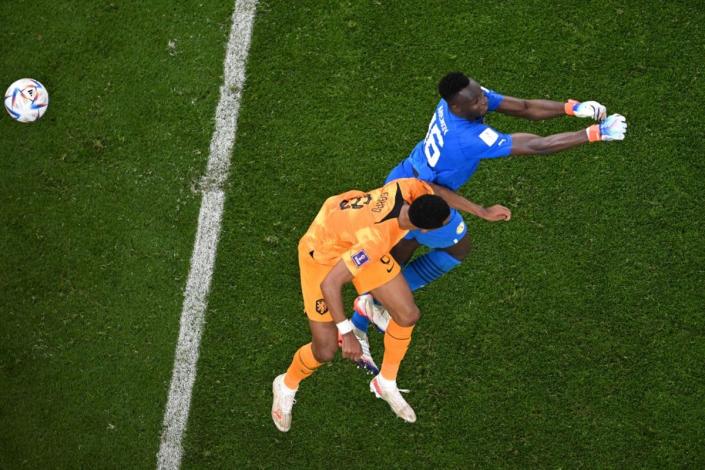 Senegal goalkeeper Mendy is caught by Gakpo’s header (AFP via Getty Images)