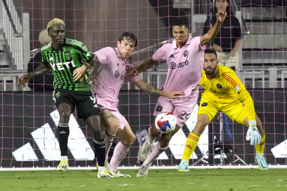 Austin FC forward Gyasi Zardes, left, attempts to shoot as Inter Miami defender Ian Fray (24) and goalkeeper Drake Callender, right, defend during the second half of an MLS soccer match, Saturday, July 1, 2023, in Fort Lauderdale, Fla. (AP Photo/Lynne Sladky)