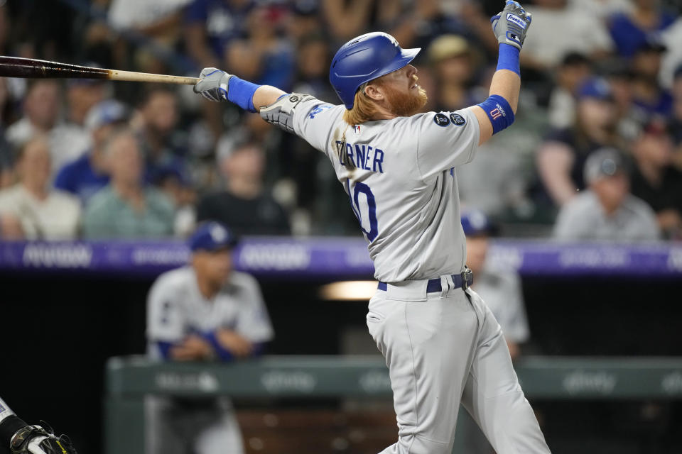 Los Angeles Dodgers' Justin Turner watches his two-run double off Colorado Rockies relief pitcher Tyler Kinley during the ninth inning of a baseball game Saturday, July 17, 2021, in Denver. (AP Photo/David Zalubowski)