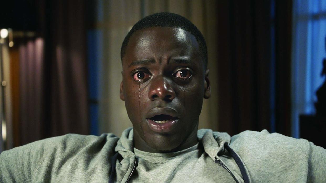  A close up of a teary eyed Chris sitting in a chair in Get Out. 