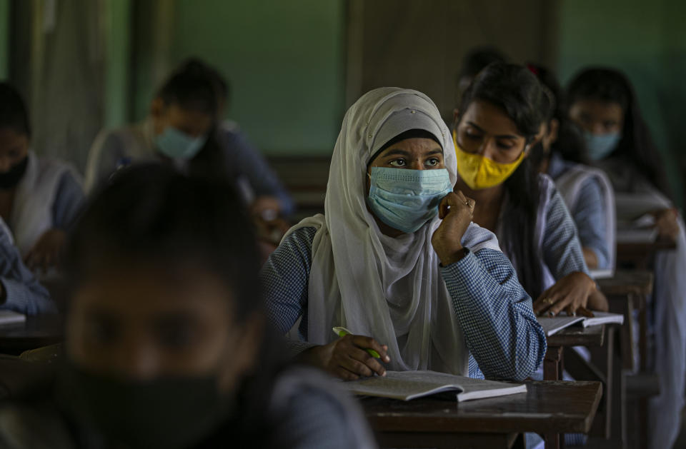 Students attend classes as schools in north-eastern Assam state reopen after being closed for months due to the coronavirus pandemic in Gauhati, India, Monday, Nov. 2, 2020. (AP Photo/Anupam Nath)