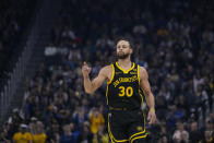 Golden State Warriors guard Stephen Curry reacts after scoring a 3-point basket during the first half of an NBA basketball game against the Memphis Grizzlies, Wednesday, March 20, 2024, in San Francisco. (AP Photo/Godofredo A. Vásquez)