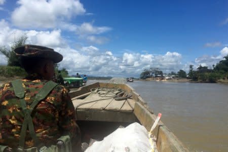 FILE PHOTO: A Myanmar soldier patrols in a boat at the Mayu river near Buthidaung in the north of Rakhine state, Myanmar September 13, 2017.  REUTERS/Stringer