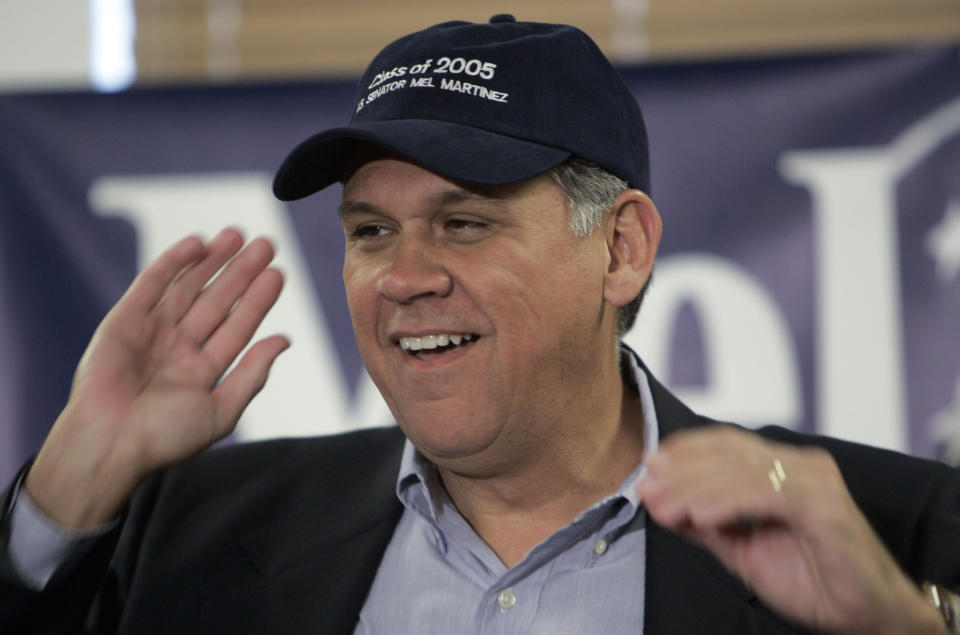 Senator-elect Mel Martinez dons a "class of 2005" hat presented him by Senate Majority Leader Bill Frist during a news conference in Orlando, Florida November 3, 2004. Martinez defeated Democrat Betty Castor for the U.S. Senate seat being vacated by Senator Bob Graham. REUTERS/Kevin Kolczynski US ELECTIONS  KK/GN