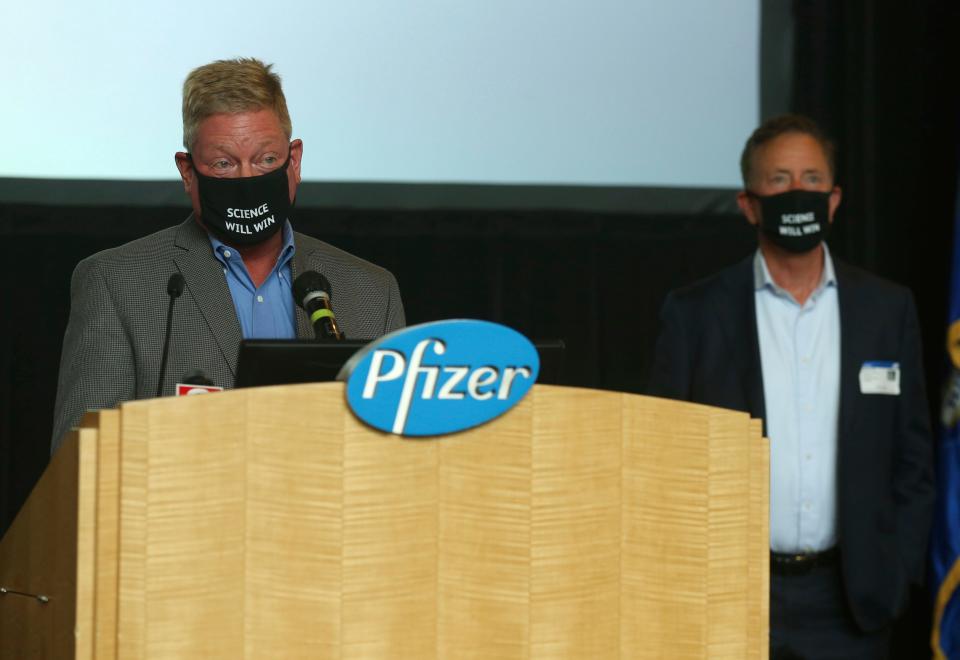 John Burkhardt, left, head of the Pfizer Groton site, speaks at a news conference as Connecticut Gov. Ned Lamont stands by to answer questions  July 22 in Groton, Conn.