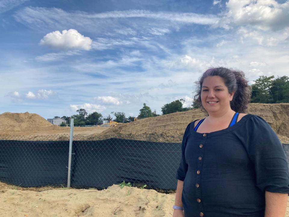 Atlantic Highlands resident Leia Sims in front of the Brant Point construction site along the Sandy Hook bayfront.