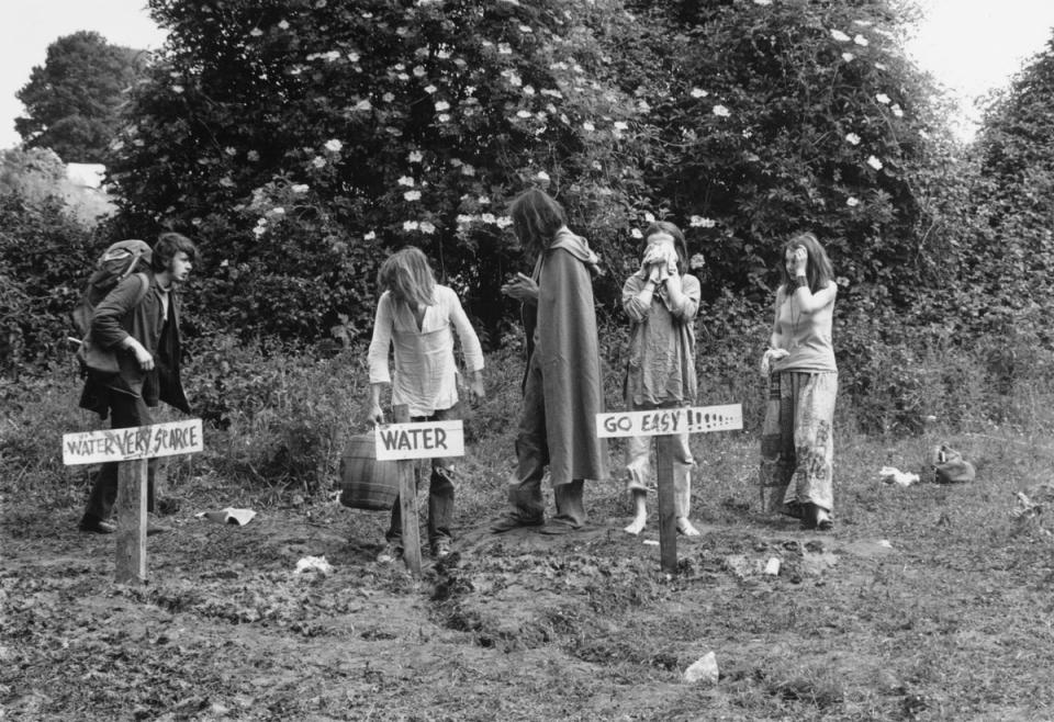 21st June 1971:  Festival-goers washing and collecting water at one of the stand pipes at Glastonbury Festival (Getty Images)