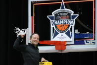North Texas head coach Grant McCasland celebrates as he cuts down the net after the championship game against Western Kentucky in the NCAA Conference USA men's basketball tournament Saturday, March 13, 2021, in Frisco, Texas. North Texas won 61-57 in overtime. (AP Photo/Tony Gutierrez)