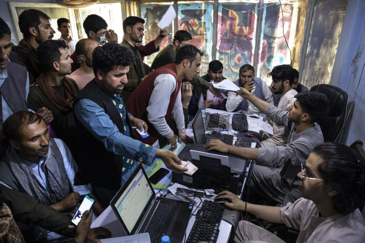 Afghan Special Immigrant Visa (SIV) applicants crowd into the Herat Kabul Internet cafe to apply for the SIV program on August 8, 2021 in Kabul, Afghanistan. Many Afghans are in desperate need of assistance completing the forms and obtaining required human resources letters, a particular challenge for those whose US government work ended years ago. (Paula Bronstein/Getty Images)