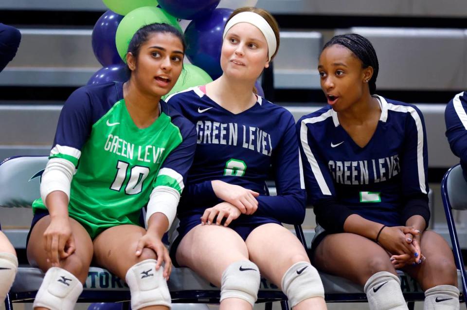 Green Level High School’s Reese Roper (8), center, talks with Aarushi Shah, left, and Jayla Edgerton during Green Level’s volleyball game against Middle Creek at Green Level High School in Cary, N.C., Tuesday, Oct. 10, 2023.