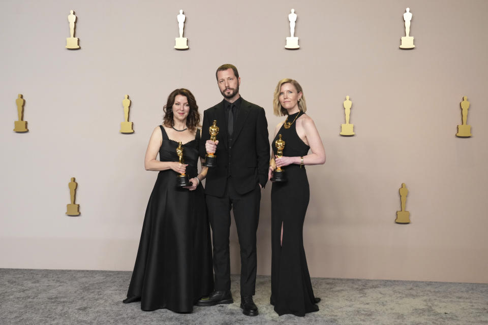 Raney Aronson-Rath, from left, Mstyslav Chernov, and Michelle Mizner pose in the press room with the award for best documentary feature film for "20 Days in Mariupol" at the Oscars on Sunday, March 10, 2024, at the Dolby Theatre in Los Angeles. (Photo by Jordan Strauss/Invision/AP)