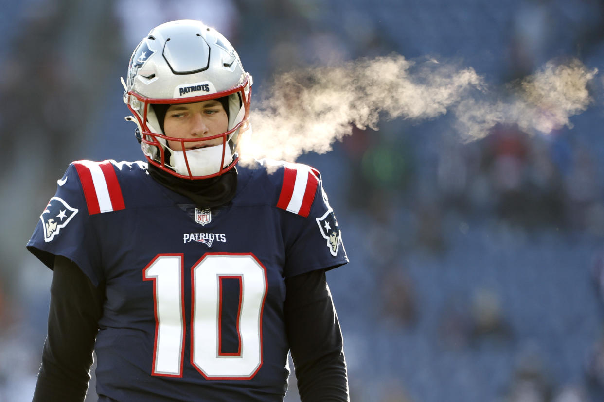 FOXBOROUGH, MASSACHUSETTS - DECEMBER 24: Mac Jones #10 of the New England Patriots looks on during pregame against the Cincinnati Bengals at Gillette Stadium on December 24, 2022 in Foxborough, Massachusetts. (Photo by Winslow Townson/Getty Images)