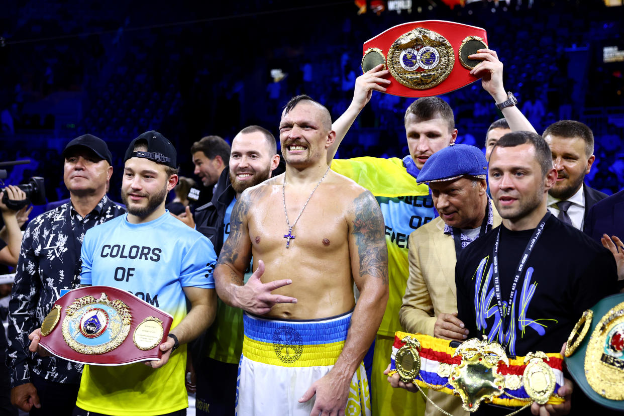 JEDDAH, SAUDI ARABIA - AUGUST 20: Oleksandr Usyk celebrates with their belts and team after their victory over Anthony Joshua in their World Heavyweight Championship fight during the Rage on the Red Sea Heavyweight Title Fight at King Abdullah Sports City Arena on August 20, 2022 in Jeddah, Saudi Arabia. (Photo by Francois Nel/Getty Images)