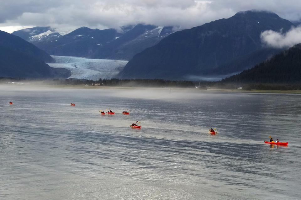 Kayakers are nearing shore on Douglas Island, with Mendenhall Glacier seen in the background in 2016, in Juneau, Alaska. (Becky Bohrer/AP)

