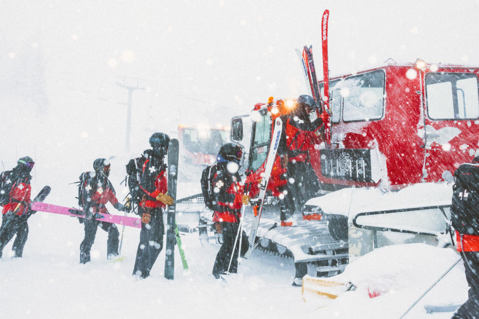 In this photo provided by Mammoth Mountain Ski Area, crew members get ready to climb on a snowplower in Mammoth Mountain in Mammoth Lakes, Calif., on Friday, April 15, 2022. California storms have blanketed the Sierra Nevada in snow. Winter isn't quite ready to give up its grip on the Eastern Sierra. Mammoth Mountain is expecting a foot of fresh snow Saturday, 8" of which are already on the hill. (Peter Morning/MMSA via AP)