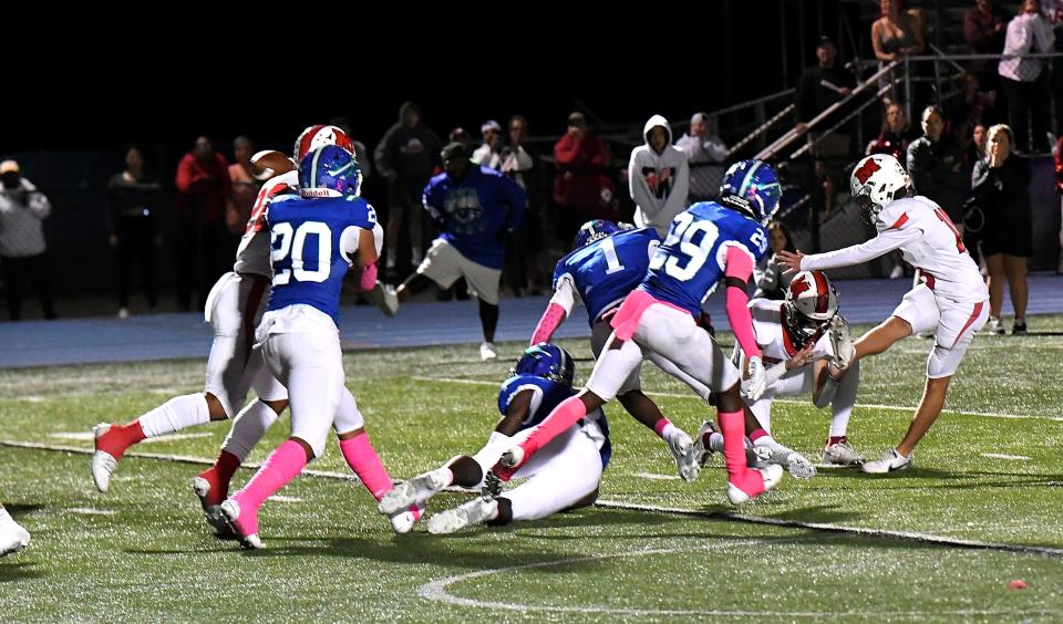 Milford's Mason Cooper (18) drives his game-winning field goal past the pressure of the Winton Woods' defense to lift the Eagles to a 3-0 ECC win over the Warriors at Winton Woods Oct. 6, 2023.