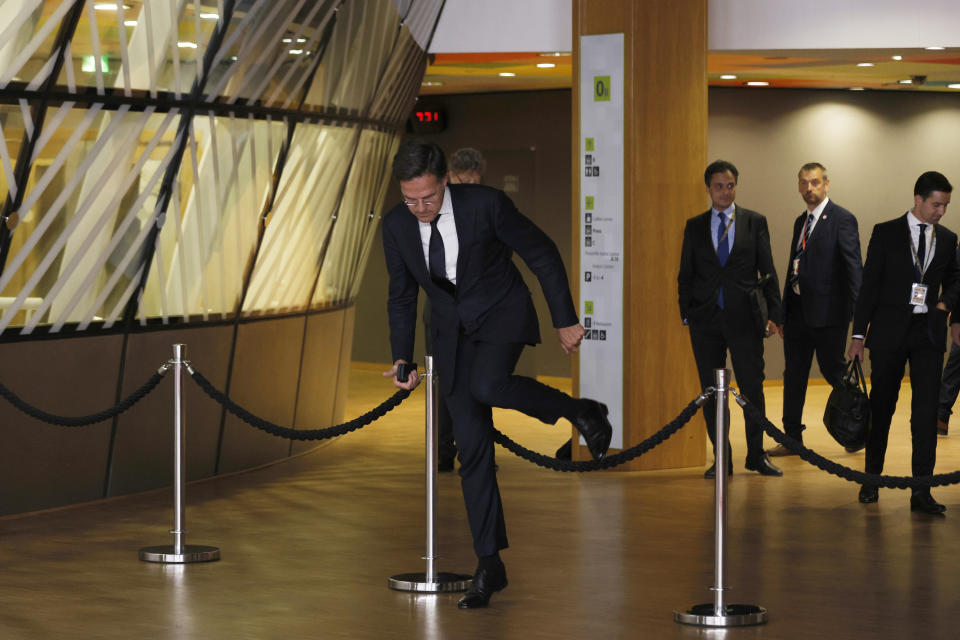 Netherland's Prime Minister Mark Rutte steps over a barrier as he prepares to address the media at the end of an EU summit in Brussels, early Tuesday, June 18, 2024. The 27 leaders of the European Union gathered in Brussels on Monday evening to take stock of recent European election results and begin the fraught process of dividing up the bloc's top jobs, but they will be playing their usual political game with a deck of reshuffled cards. (AP Photo/Omar Havana)