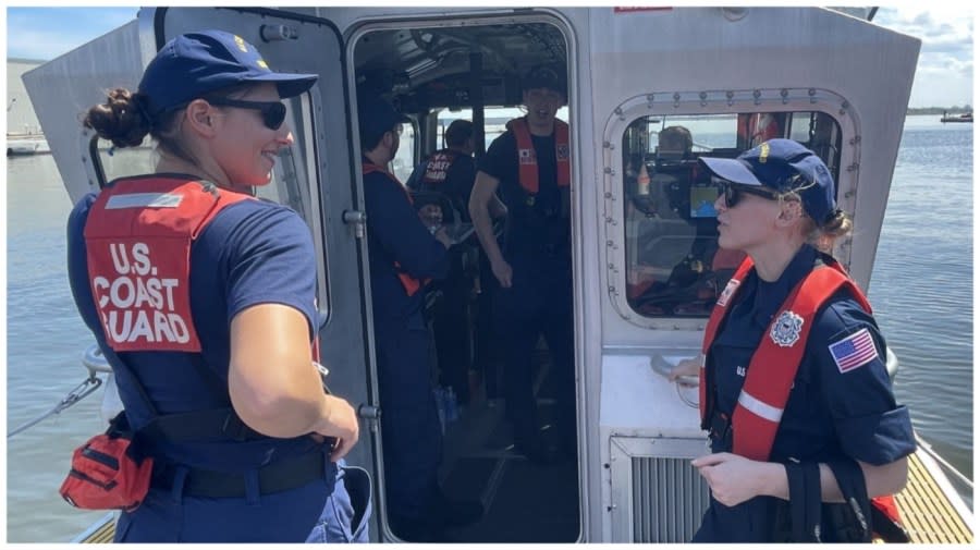 U.S. Coast Guard crew chat on a small boat headed toward the debris field of the Francis Scott Key Bridge on March 26, 2024.