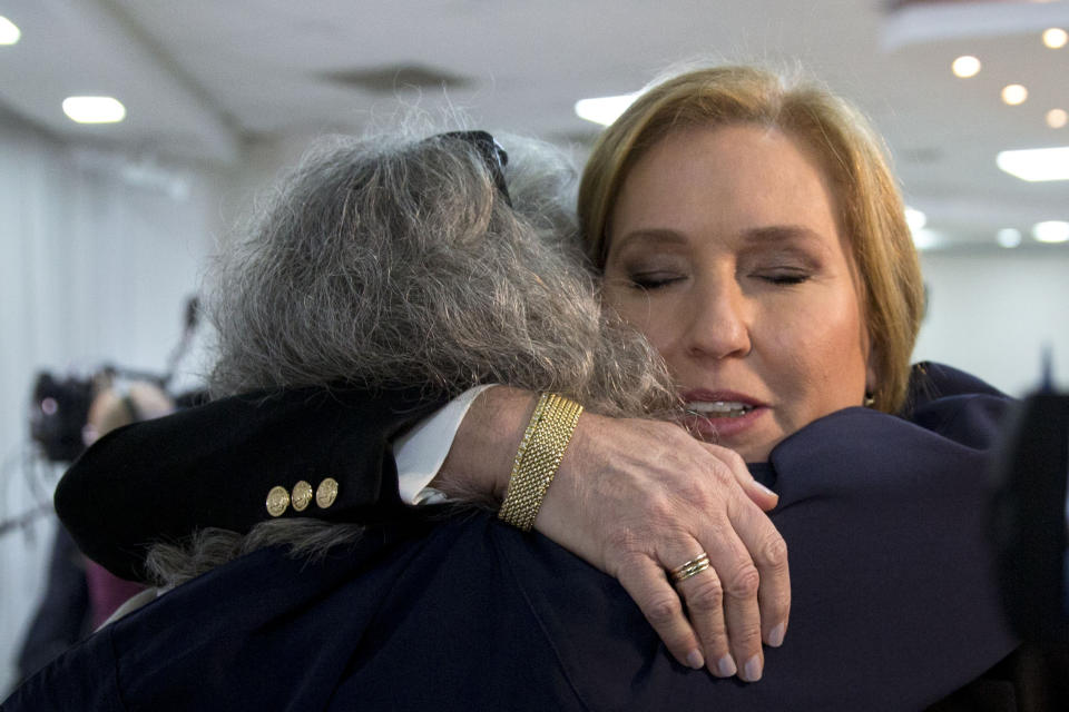 Former Israeli Foreign Minister Tzipi Livni hugs a supporter prior to a press conference in Tel Aviv, Israel, Monday, Feb. 18, 2019. Livni, on Monday, announced her retirement from politics. (AP Photo/Sebastian Scheiner)