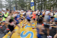 FILE - Runners cross the starting line during the 127th Boston Marathon, Monday, April 17, 2023, in Hopkinton, Mass. Once a year for the last 100 years, Hopkinton becomes the center of the running world, thanks to a quirk of geography and history that made it the starting line for the world's oldest and most prestigious annual marathon. (AP Photo/Mary Schwalm, File)