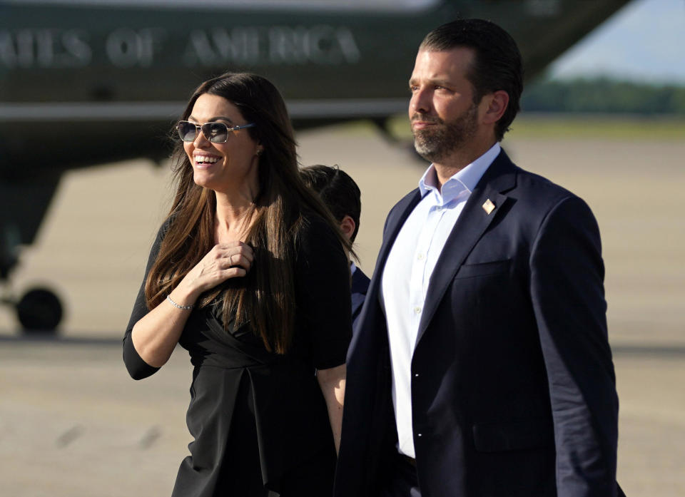 In this May 27, 2020, file photo, Donald Trump Jr., walks with his girlfriend Kimberly Guilfoyle after arriving at Andrews Air Force Base, Md., after traveling to Florida, with President Donald Trump. / Credit: Evan Vucci / AP