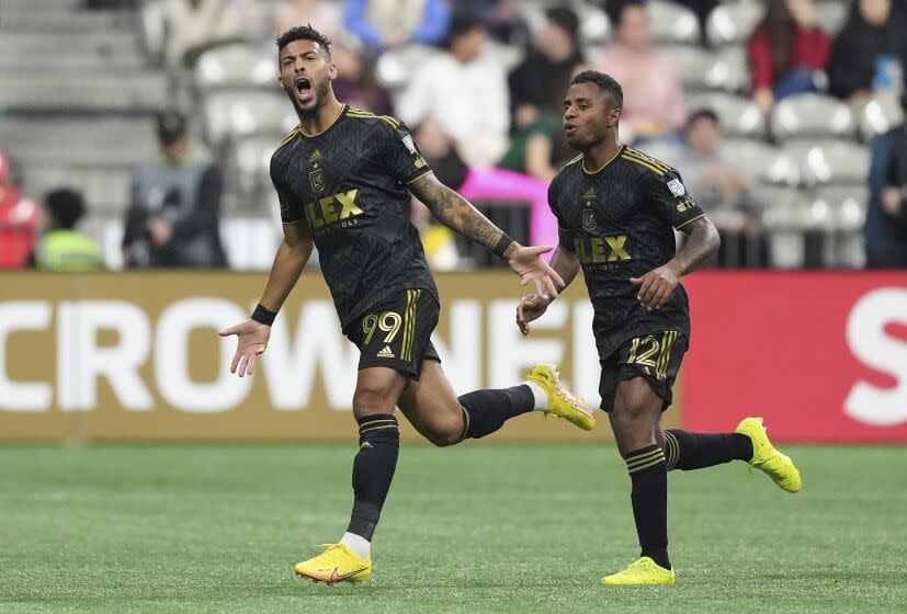 Los Angeles FC's Denis Bouanga, left, and Diego Palacios celebrate Bouanga's first goal against the Vancouver Whitecaps, during the second half of a CONCACAF Champions League soccer match Wednesday, April 5, 2023, in Vancouver, British Columbia. (Darryl Dyck/The Canadian Press via AP)