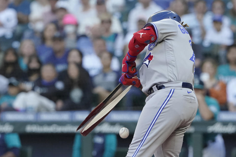 Toronto Blue Jays' Vladimir Guerrero Jr. breaks his bat as he grounds out during the first inning of the team's baseball game against the Seattle Mariners, Friday, July 8, 2022, in Seattle. (AP Photo/Ted S. Warren)