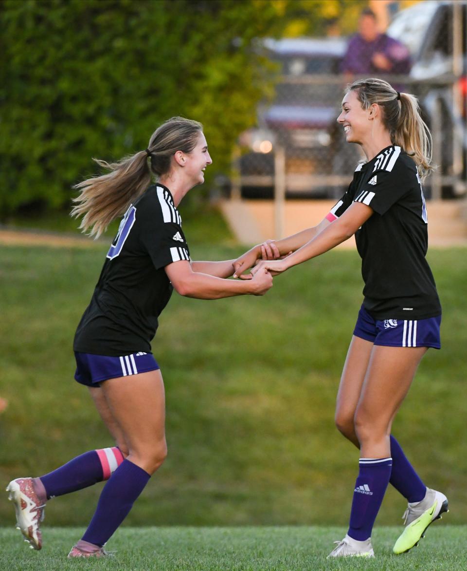 Bloomington South’s Annalise Coyne (left) congratulates Keira Robinson after a goal during the girls’ soccer match against Terre Haute North at South on Wednesday, August 30, 2023.