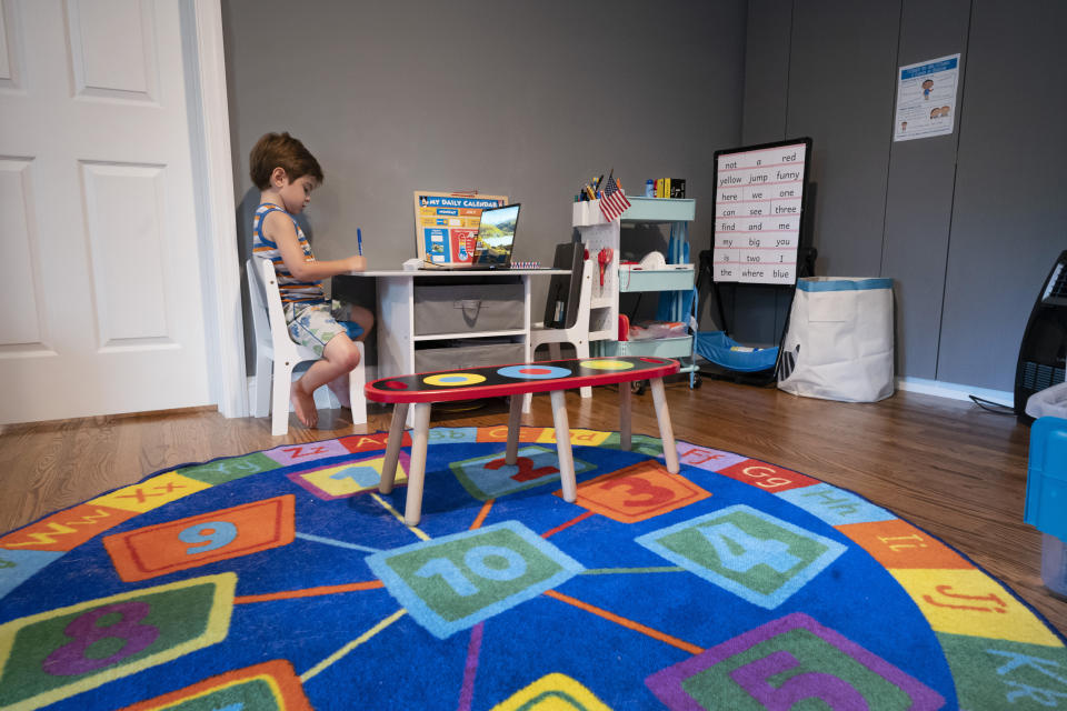 Logan Strauss, 5, does his school work at home with his laptop while participating in an online class in Basking Ridge, N.J., Wednesday, July 28, 2021. Logan's parents are keeping him out of school until he gets the COVID-19 vaccine. (AP Photo/Mark Lennihan)