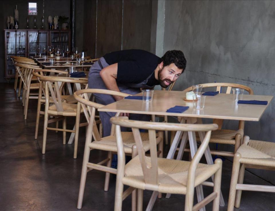 Chef Juan Camilo Liscano checks the table settings at Palma.