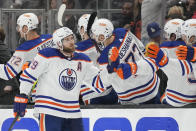 Edmonton Oilers center Leon Draisaitl (29) celebrates with teammates after scoring during the second period of Game 4 of an NHL hockey Stanley Cup first-round playoff series hockey game Sunday, April 23, 2023, in Los Angeles. (AP Photo/Ashley Landis)