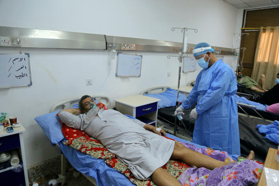 Coronavirus patients receive treatment at a hospital in Najaf, Iraq, Wednesday, July 14, 2021. Infections in Iraq have surged to record highs amid a third wave spurred by the more aggressive delta variant, and long-neglected hospitals suffering the effects of decades of war are overwhelmed with severely ill patients. (AP Photo/Anmar Khalil)