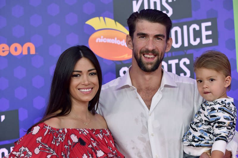 Michael Phelps (C) and Nicole Phelps (L), pictured with son Boomer, recently welcomed their fourth child. File Photo by Chris Chew/UPI