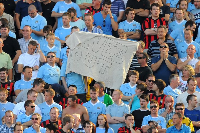 Manchester City fans hold a 'Tevez out' at Ewood Park in October 2011.