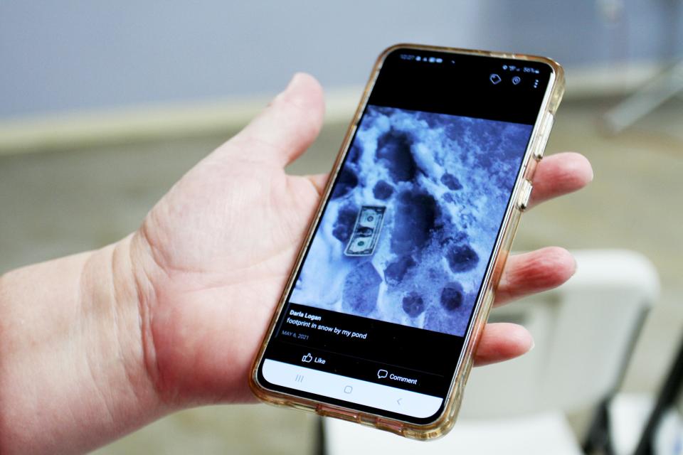 Darla Logan holds her phone as it displays a photo she took in 2006 of footprints she says supposedly belong to Bigfoot.