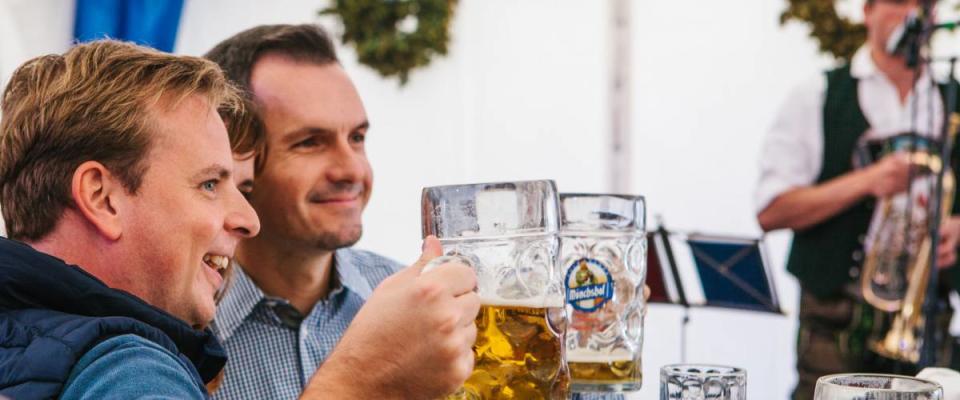 Prague, September 23, 2017: Celebrating the traditional German beer festival called Oktoberfest in the Czech Republic. Friends rejoice and drink fresh German beer together.