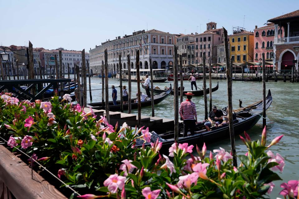 Tourists board Venetian gondolas for a tour, in Venice, Italy, Thursday, June 17, 2021.