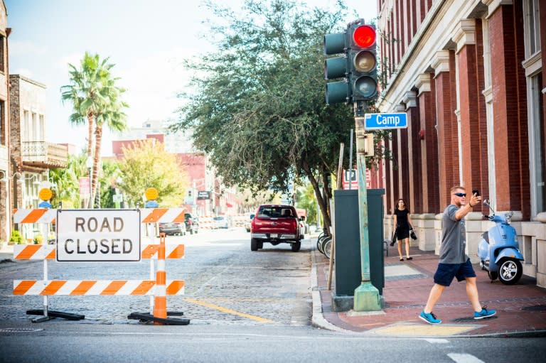 Pedestrians walk past the road closure outside the Contemporary Arts Museum, where Serena Williams will be getting married in New Orleans, Louisiana