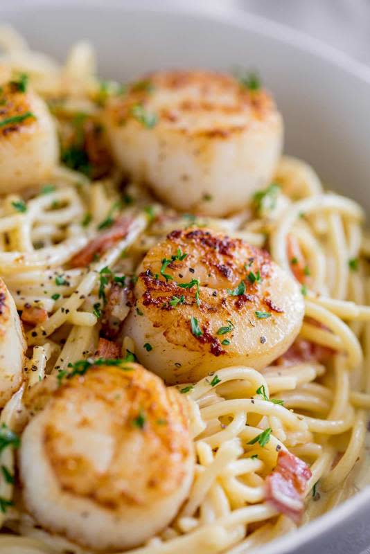 <p>Sprinkles and Sprouts</p><p>This seared scallop pasta with creamy bacon sauce is such an easy elegant seafood recipe.</p><p><strong>Get the recipe: <a href="https://www.sprinklesandsprouts.com/scallop-bacon-pasta/" rel="nofollow noopener" target="_blank" data-ylk="slk:Scallop Bacon Pasta;elm:context_link;itc:0;sec:content-canvas" class="link rapid-noclick-resp">Scallop Bacon Pasta</a></strong></p>