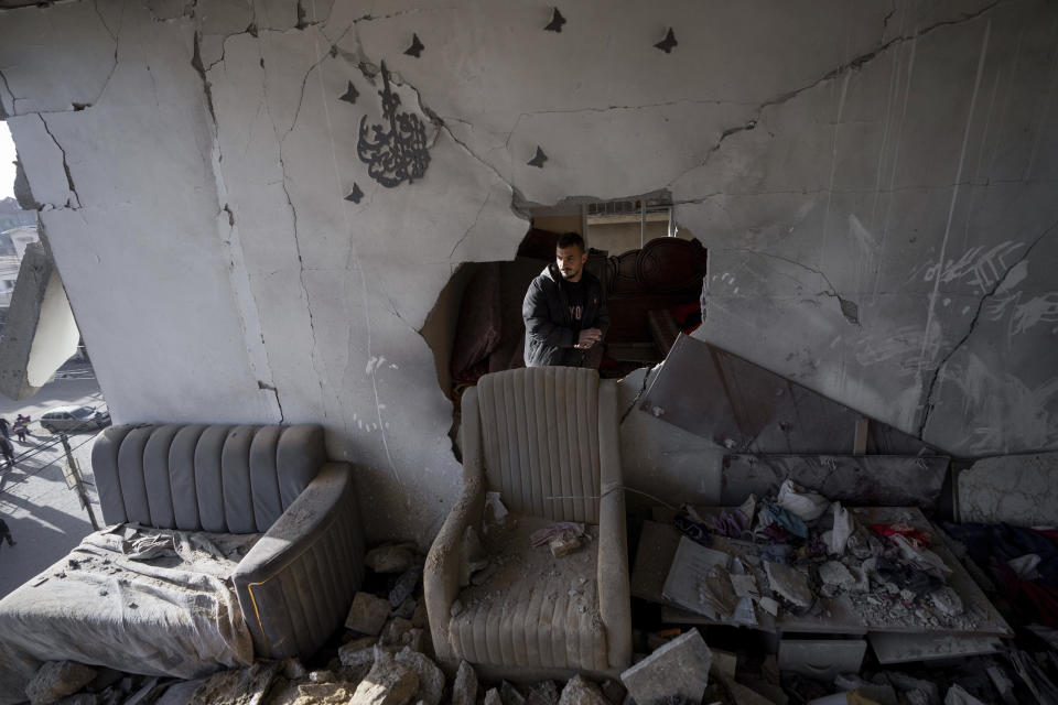 Palestinians look at a damaged residential building after an Israeli strike in Rafah, southern Gaza Strip, Wednesday, Jan. 10, 2024. (AP Photo/Fatima Shbair)