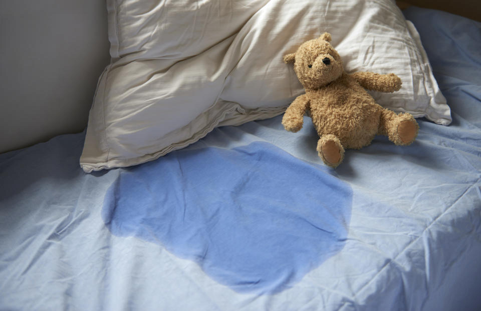 wet pee stain on a child's bed